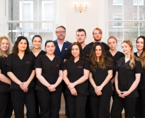 Group photo of the Vinci Hair Clinic team, featuring a diverse group of technicians, a doctor, and the CEO, standing together in a united pose, reflecting the collaborative and professional environment dedicated to hair restoration and patient care.
