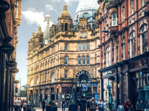 A street view of the Leeds city centre with  historic buildings, near vinci hair clinic Leeds