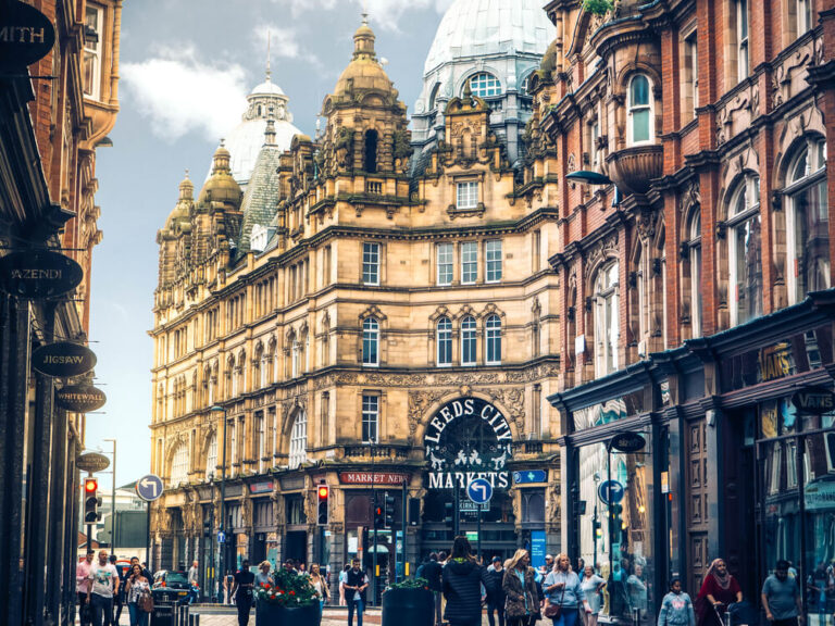 A street view of the Leeds city centre with  historic buildings, near vinci hair clinic Leeds