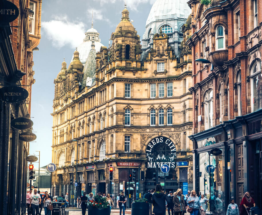 A street view of the Leeds city centre with historic buildings, near vinci hair clinic Leeds